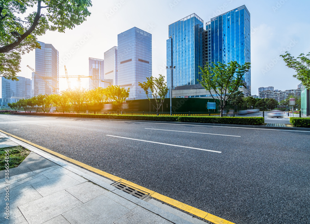 Obraz premium empty asphalt road front of modern buildings.