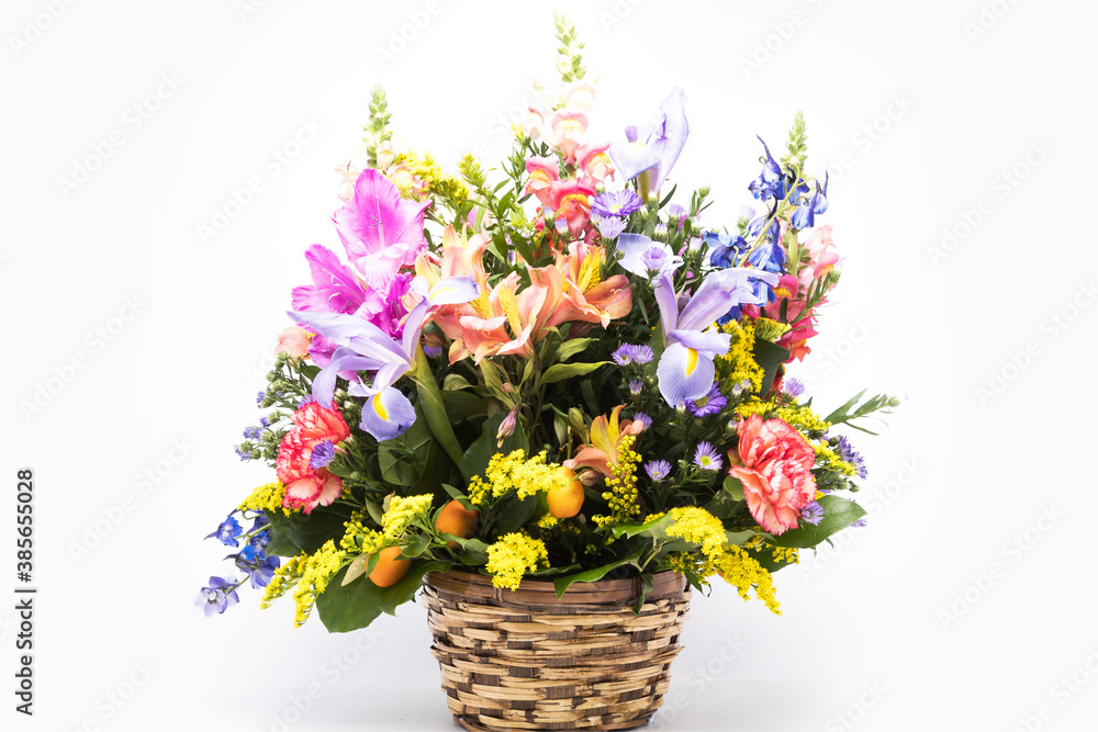 bouquet of bright flowers in basket isolated on white background. Mothers Day or Valentines Day Concept