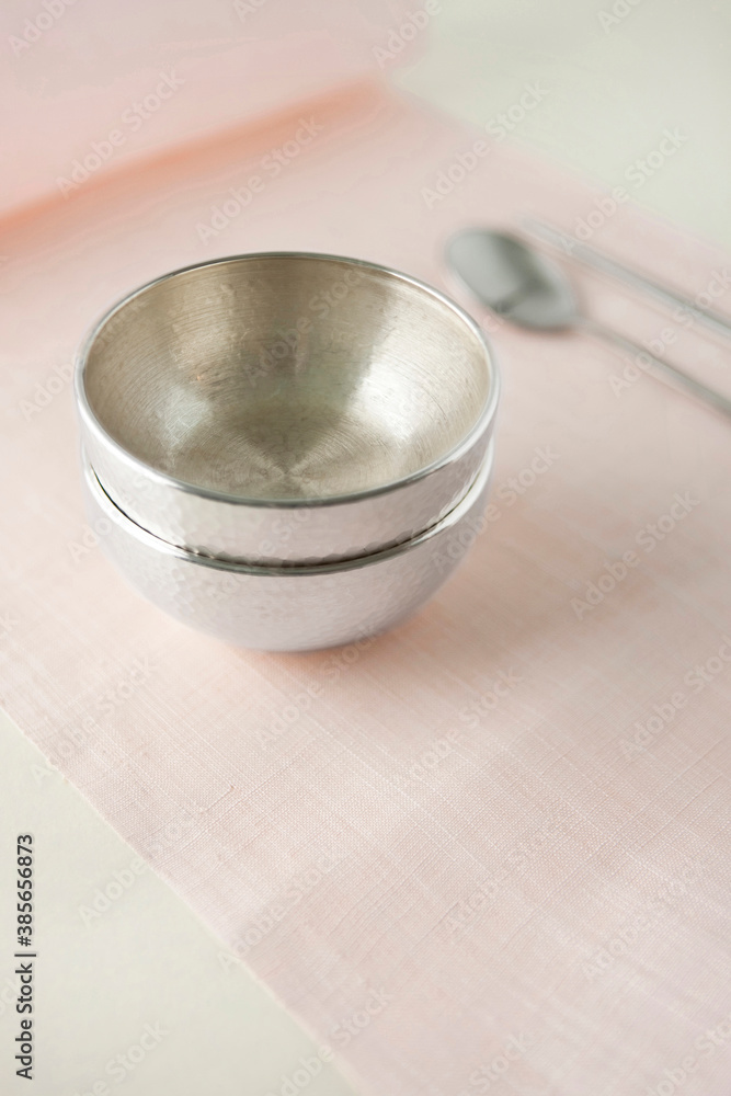 Korean traditional silverwares on pink ramie cloth. Korean traditional silverwares on pink ramie cloth.