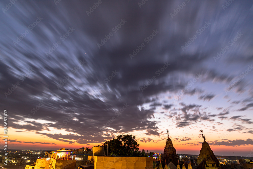 dramatic sky and jain temple of jaisalmer