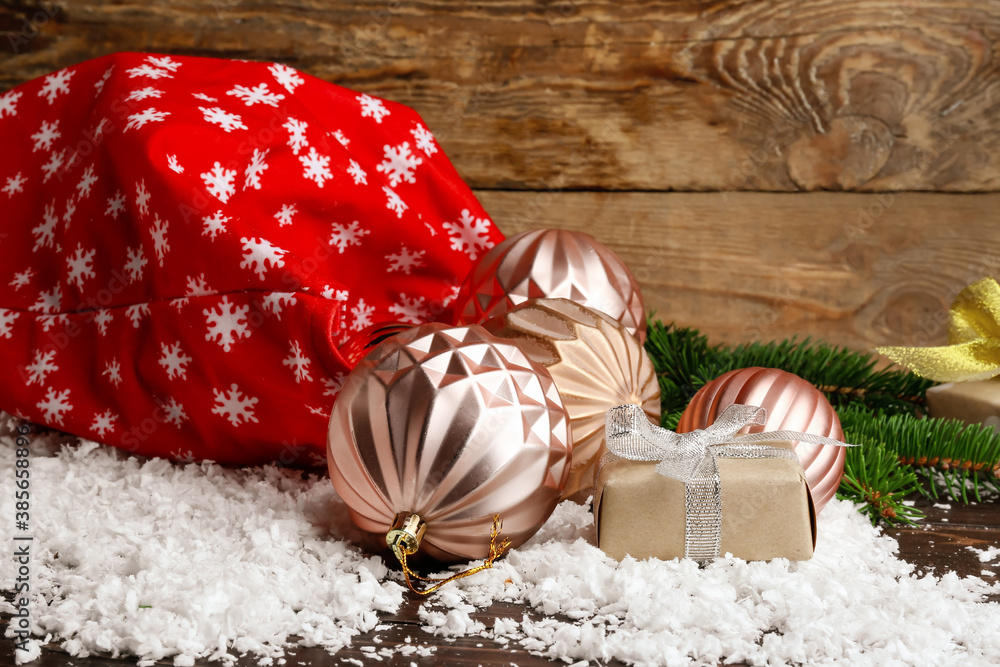 Santa bag with gifts and decor on wooden background Stock Photo | Adobe