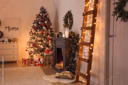 Decorated fireplace in interior of room on Christmas eve © Pixel-Shot