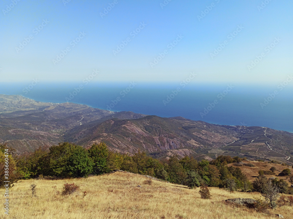 Obraz premium Amazing view on sea and mountains in the distance in hot summer. Vacation, summer travel. Black sea, seacoast. Crimea. 