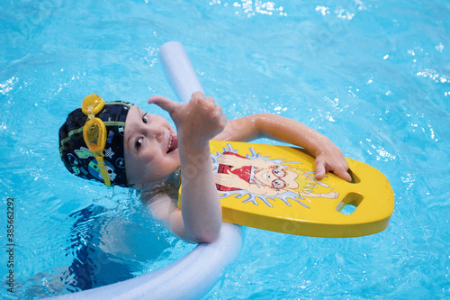 little boy swimming in the pool.Swimming lessons for little ones