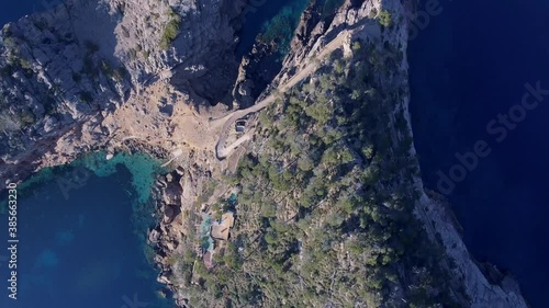 4k top down shot of spanish rocky coastline - Sa Foradada Mallorca, Serra de Tramuntana - Westcoast - Calm turquoise Mediterranean Sea photo