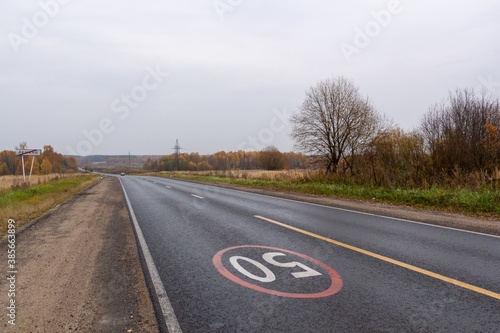Wallpaper Mural wet road in the middle of nowhere with 50 speed limit in cloudy autumn day Torontodigital.ca