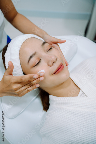 Woman face getting a spa treatment in beauty clinic.