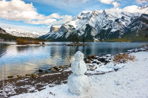 Snowman at shore of Lake Minnewanka after early snowfall in Banff National Park, Canadian Rocky Mountains photo