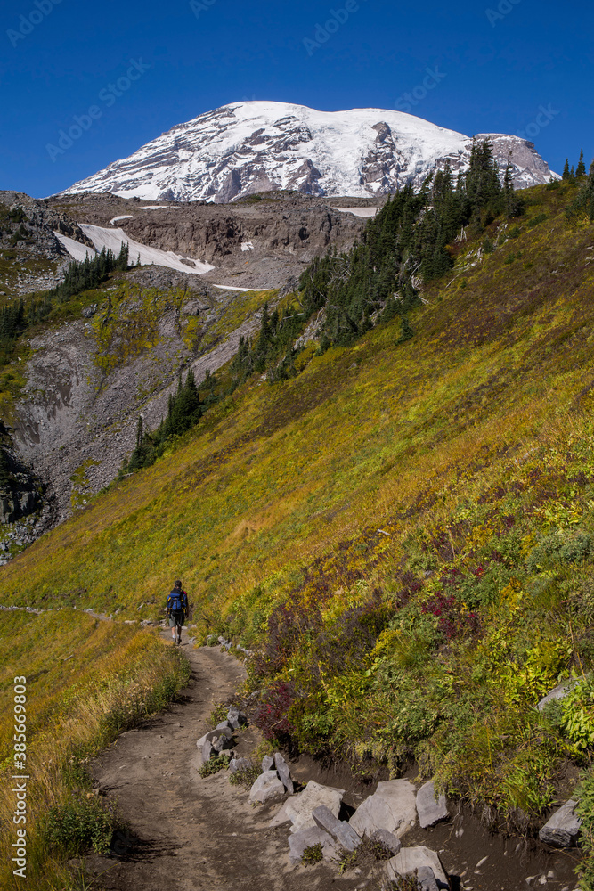 Hiker on a trail at Mt. Rainier National Park in early fall
