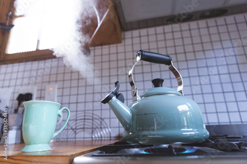 Close up of kettle on gas burner in kitchen