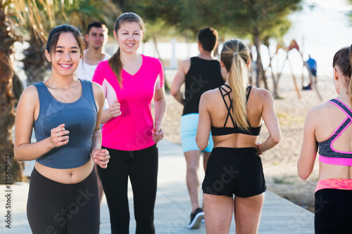 Active smiling people during running training in daytime