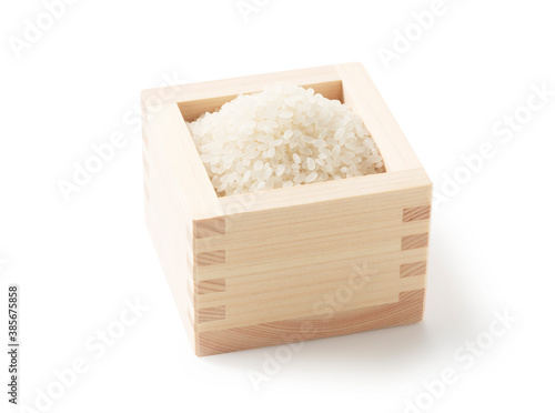 Rice in a measuring cup on a white background