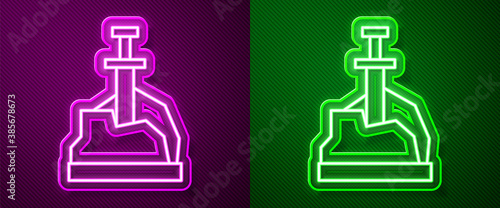 Glowing neon line Sword in the stone icon isolated on purple and green background. Excalibur the sword in the stone from the Arthurian legends. Vector.