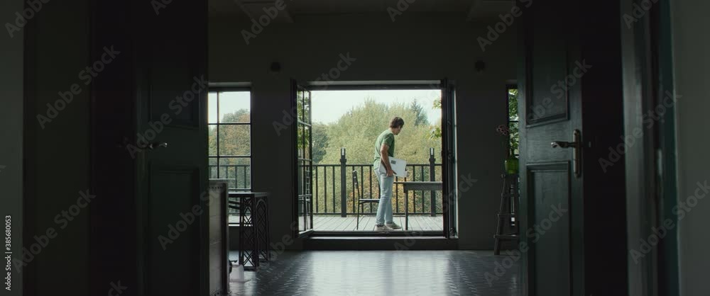DOLLY IN 40s Caucasian male working from home, bringing laptop to house outdoor terrace. Working during COVID-19 isolation. Shot on RED Epic with 2x Anamorphic lens DOLLY IN 40s Caucasian male working from home, bringing laptop to house outdoor terrace. Working during COVID-19 isolation. Shot on RED Epic with 2x Anamorphic lens