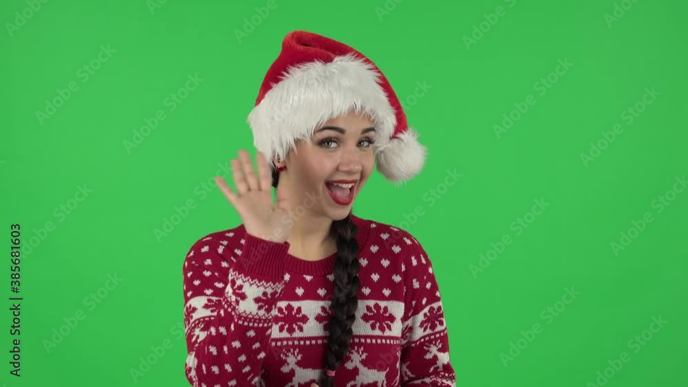 Portrait of sweety girl in Santa Claus hat is screaming calling someone. Green screen Portrait of sweety girl in Santa Claus hat is screaming calling someone. Green screen