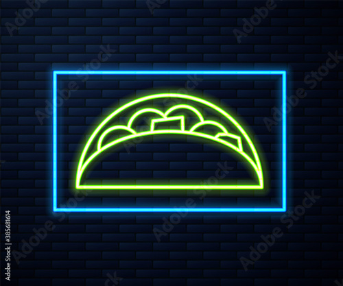 Glowing neon line Taco with tortilla icon isolated on brick wall background. Traditional mexican fast food menu. Vector.