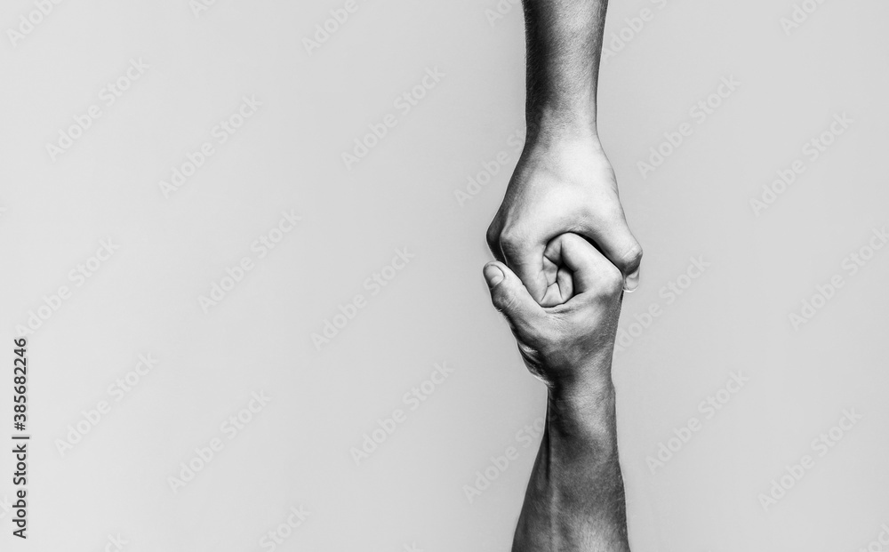 Two hands, helping arm of a friend, teamwork. Helping hand concept and international day of peace, support. Black and white - obrazy, fototapety, plakaty 