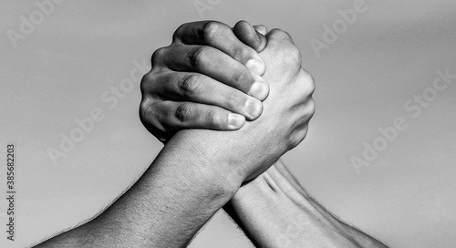 Hand, rivalry, vs, challenge, strength comparison. Two muscular hands. Rivalry concept. Two men arm wrestling. Arms wrestling. Friendly handshake, friends greeting, teamwork.