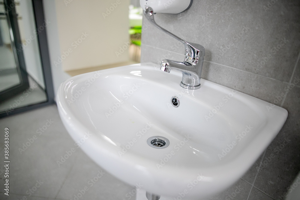Clean faucet with sink in a public place Clean faucet with sink in a public place