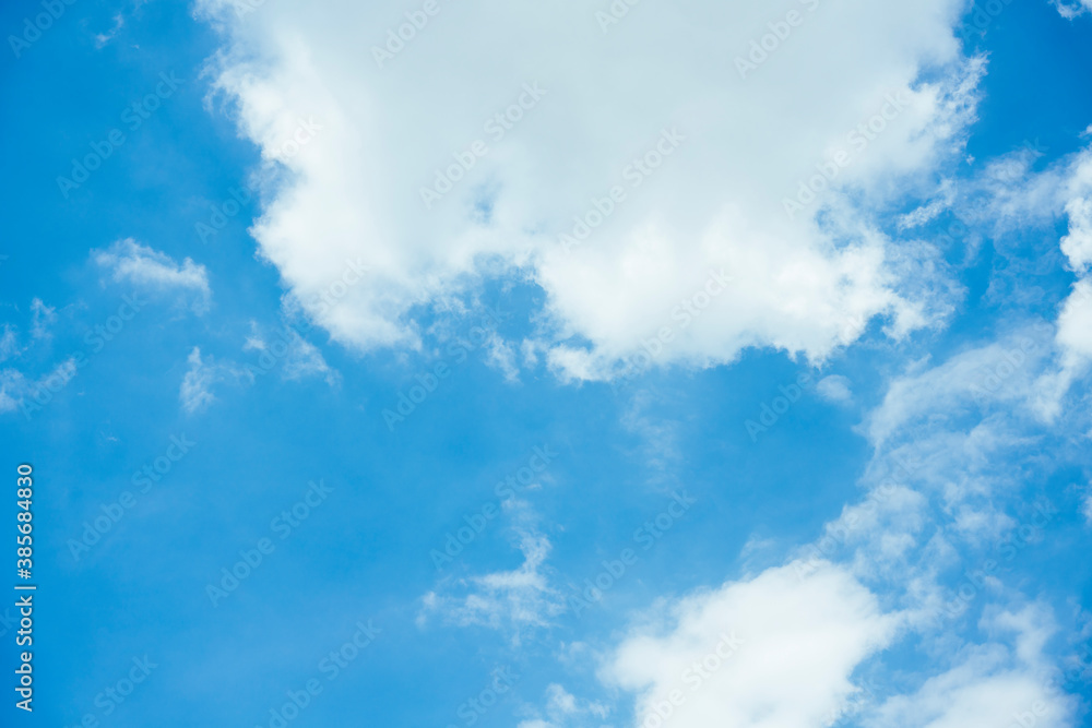 Cloudscape with fluffy white cloud in blue sky.