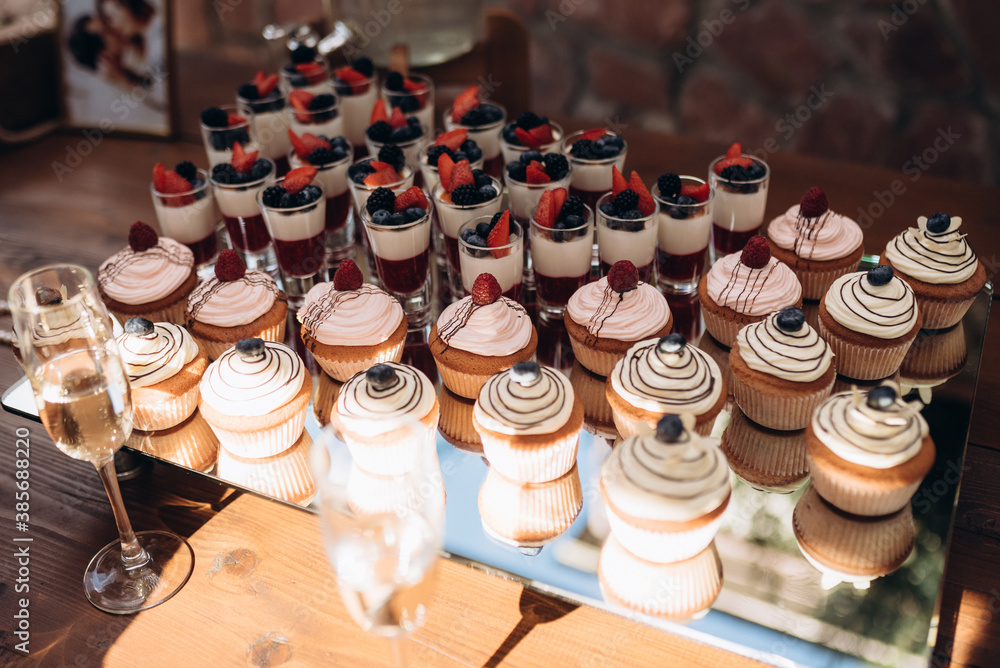 colorful cupcakes frosted with a variety of frosting flavors colorful cupcakes frosted with a variety of frosting flavors