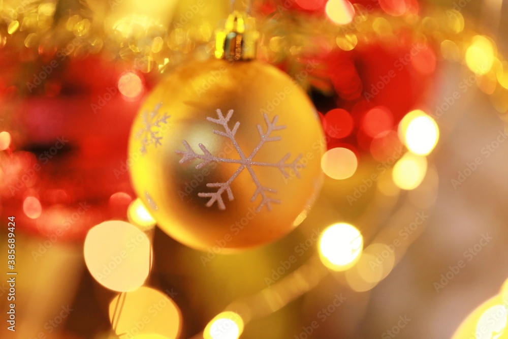 Christmas and New Year background.Golden and red decorative ball and shining garlands decoration on the christmas tree.Christmas tree festive decor.Winter holidays symbol.holidays wallpaper Christmas and New Year background.Golden and red decorative ball and shining garlands decoration on the christmas tree.Christmas tree festive decor.Winter holidays symbol.holidays wallpaper