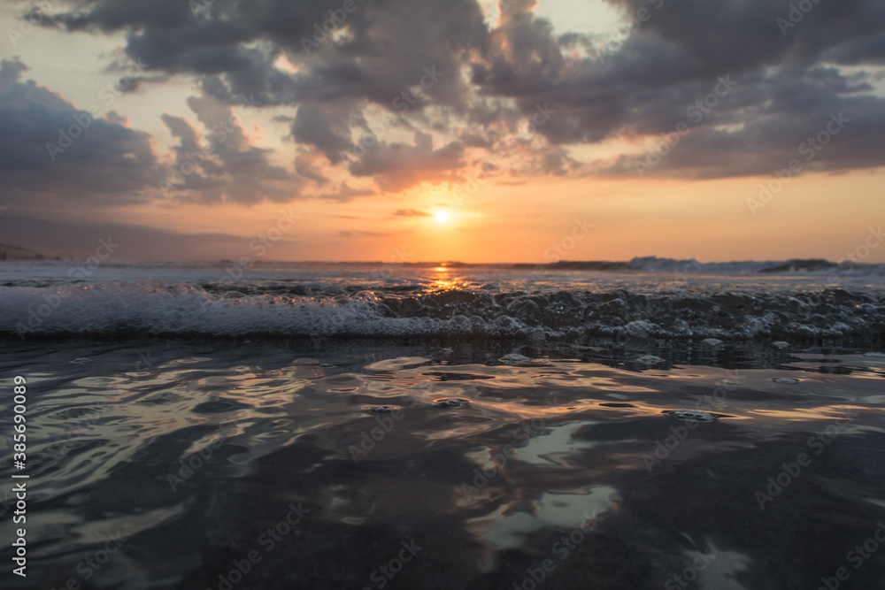 Sunset in the shore of the mediterranean sea of algeria Sunset with sandy beaches, clouds and waves in the sea Sunset in the shore of the mediterranean sea of algeria Sunset with sandy beaches, clouds and waves in the sea