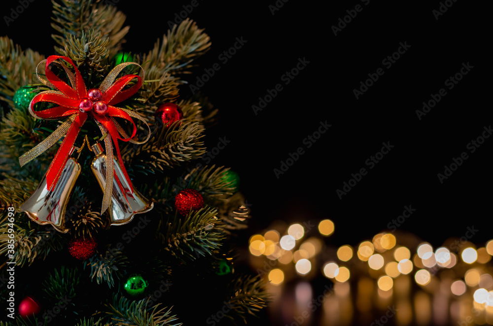The  bell ornaments decorate on Christmas tree with bokeh lights background. Christmas and New year concept.
