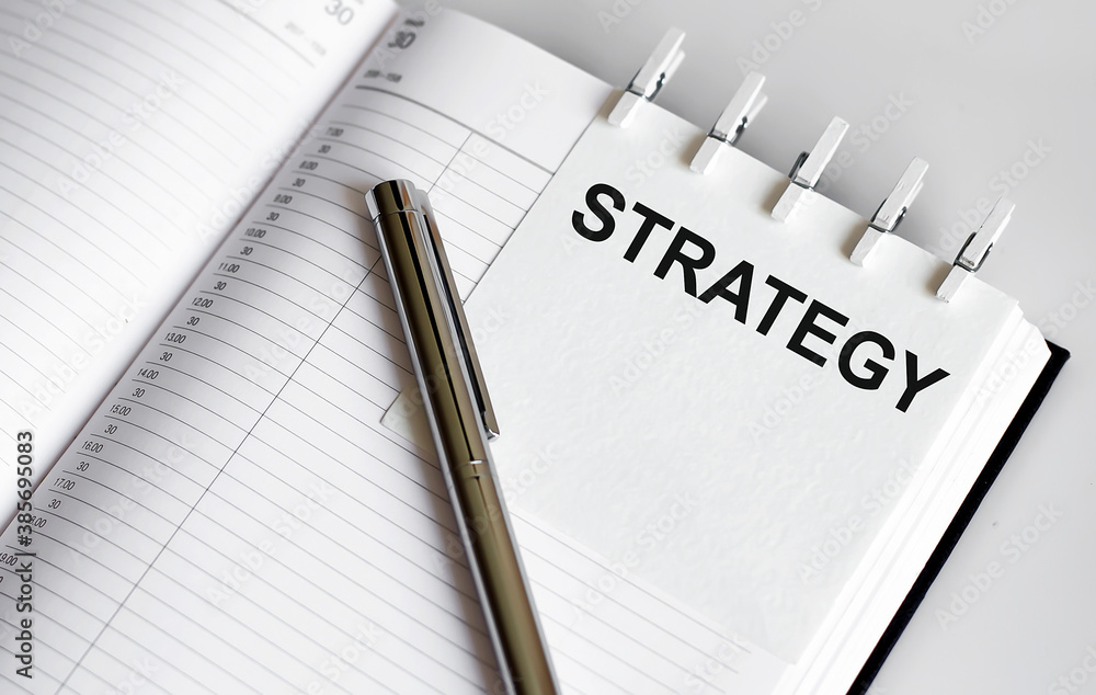text STRATEGY on the short note texture background with pen text STRATEGY on the short note texture background with pen