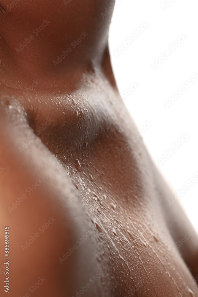 Close up of female neck and shoulder with water drops in beautiful shine. African-american model. Beauty, fashion, skincare, cosmetics concept. Copyspace for ad. Well-kept skin, fresh look. Close up of female neck and shoulder with water drops in beautiful shine. African-american model. Beauty, fashion, skincare, cosmetics concept. Copyspace for ad. Well-kept skin, fresh look.