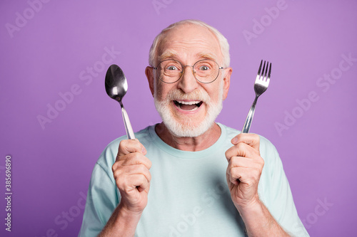Canvastavla Photo of positive smiling grandfather hold cutlery wear light blue t-shirt isola