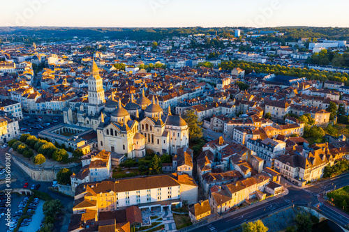 Drone view of French city of Perigueux on Isle River overlooking Romanesque building of ancient cathedral during summer sunrise, Dordogne