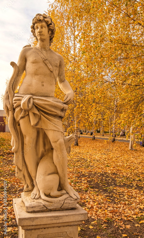 Garden plaster statue depicting  allegorical figure of  hunter in  autumn park. (not  work of art, stamping)