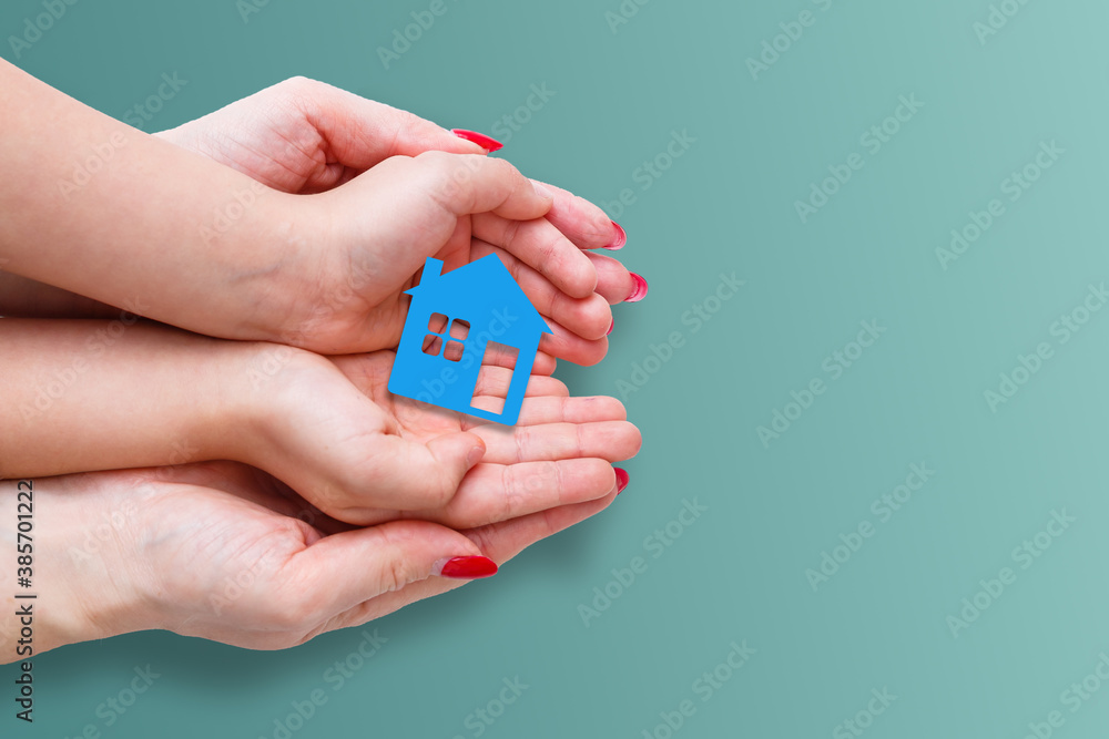 people, charity, family and home concept - close up of woman and girl holding paper house cutout in cupped hands people, charity, family and home concept - close up of woman and girl holding paper house cutout in cupped hands