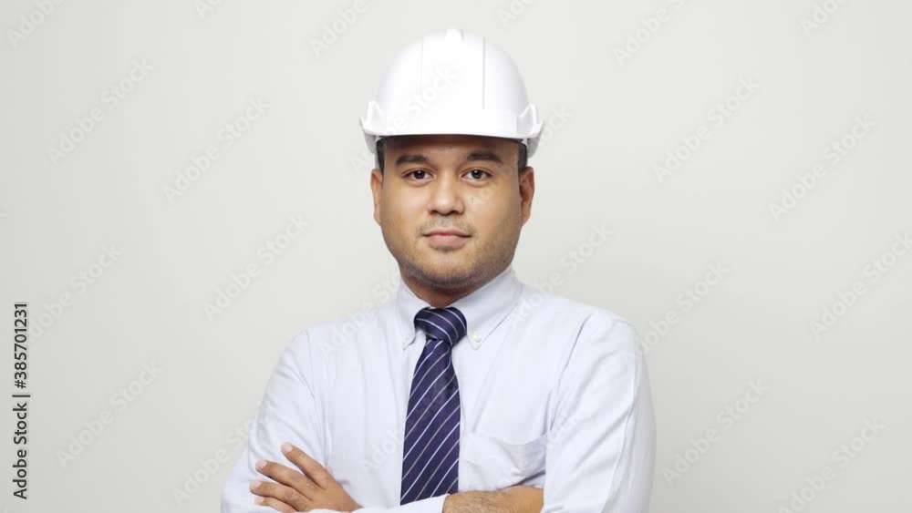 Smiling young asian civil engineer wearing safety glasses and helmet hard hat standing on isolated white background. Mechanic service concept. 4k resolution. Smiling young asian civil engineer wearing safety glasses and helmet hard hat standing on isolated white background. Mechanic service concept. 4k resolution.