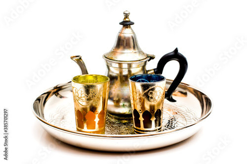 Group of teapot and glasses of oriental tea on a tray on white background