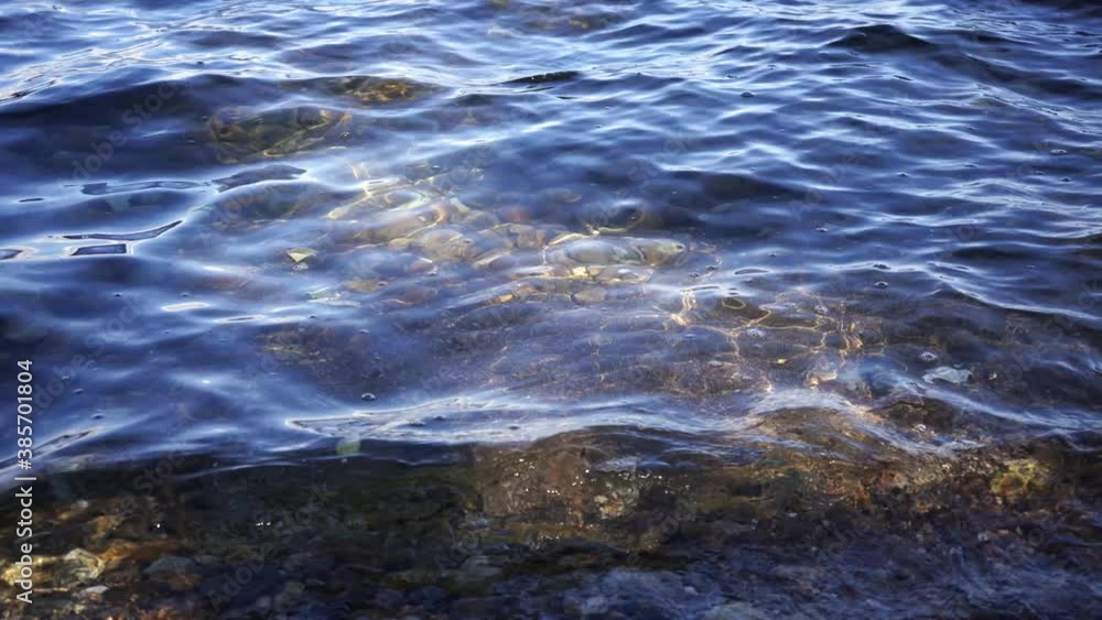 Natural background with rocks on the shore and water surface Natural background with rocks on the shore and water surface