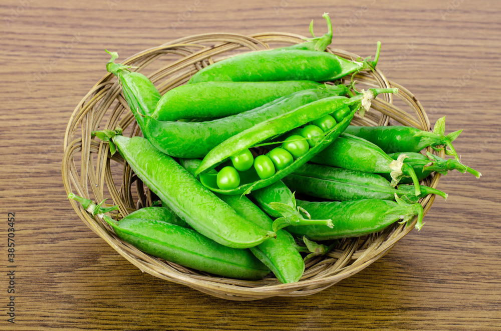 Ripe green peas pods on wooden background. Ripe green peas pods on wooden background.