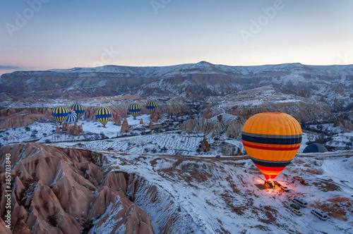 Hot air balloons are flying over Cappadocia. Cappadocia is the most populer tourist destination in Turkey.