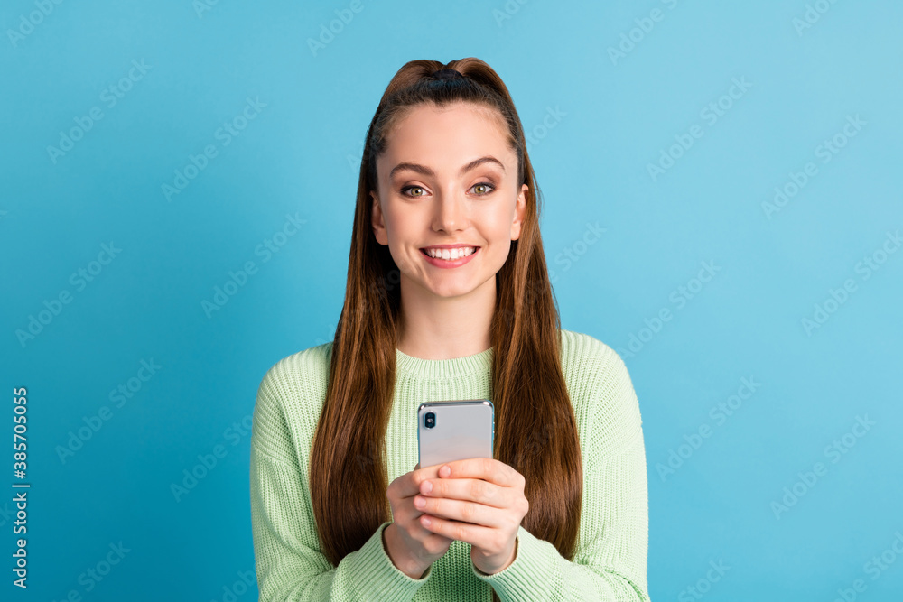 Close-up portrait of her she nice attractive lovely pretty cheerful cheery brown-haired girl using device browsing news smm comment isolated bright vivid shine vibrant blue color background