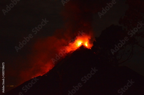 Sunrise hiking and camping on the active Volcan Acatenango with a view to the volcano Fuego eruption - Guatemala