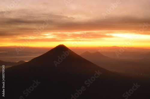 Sunrise hiking and camping on the active Volcan Acatenango with a view to the volcano Fuego eruption - Guatemala © ChrisOvergaard