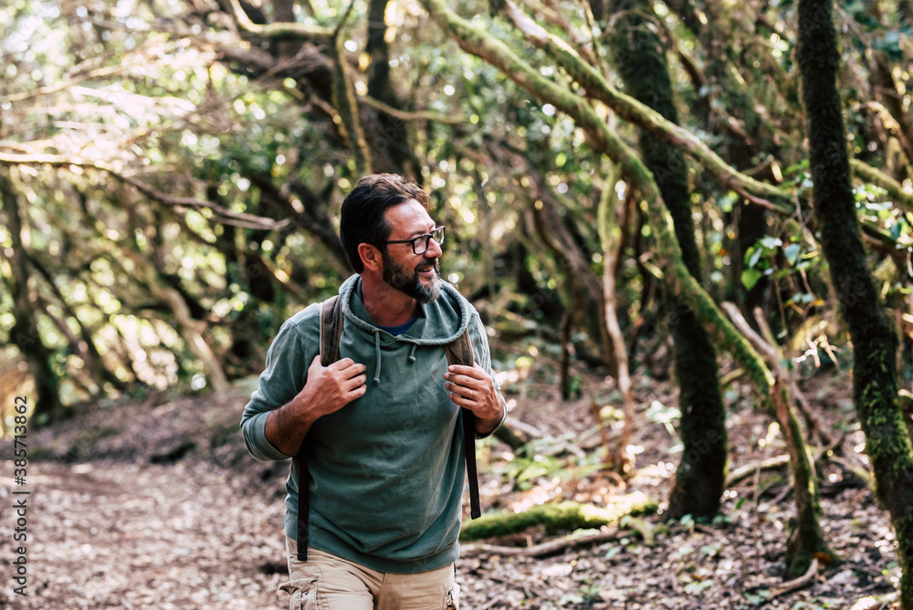 Portrait of man with backpack enjoying outdoor leisure activity walking in the wood forest alone - people and nature - tourism excursion with cheerful and happy caucasian male Portrait of man with backpack enjoying outdoor leisure activity walking in the wood forest alone - people and nature - tourism excursion with cheerful and happy caucasian male