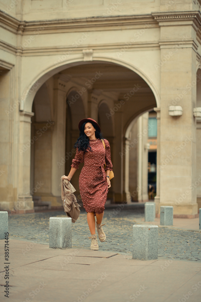 Young woman walking happily on the streets of Bucharest