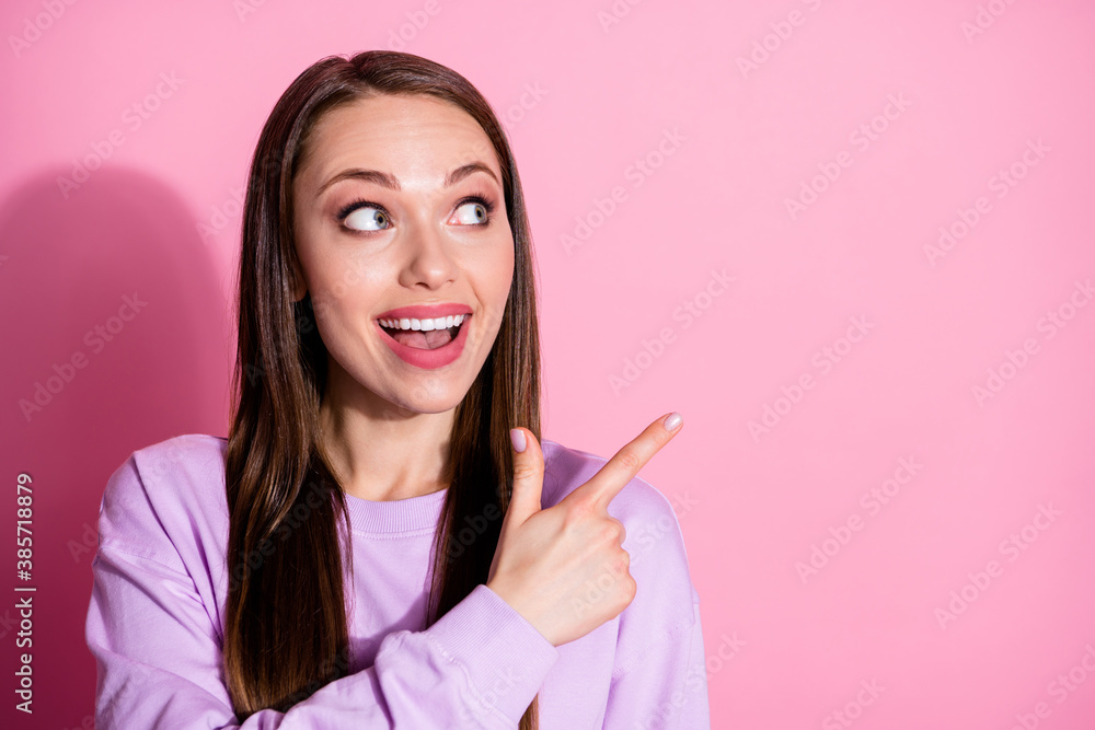 Closeup photo of attractive excited lady direct fingers look side empty space show novelty banner sale shopping center wear casual purple sweater isolated pink pastel color background Closeup photo of attractive excited lady direct fingers look side empty space show novelty banner sale shopping center wear casual purple sweater isolated pink pastel color background