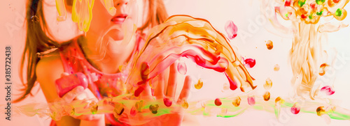 Portrait of beautiful girl painting artwork on glass. Happiness  childhood  art  painting lessons concept. Selective focus on finger.