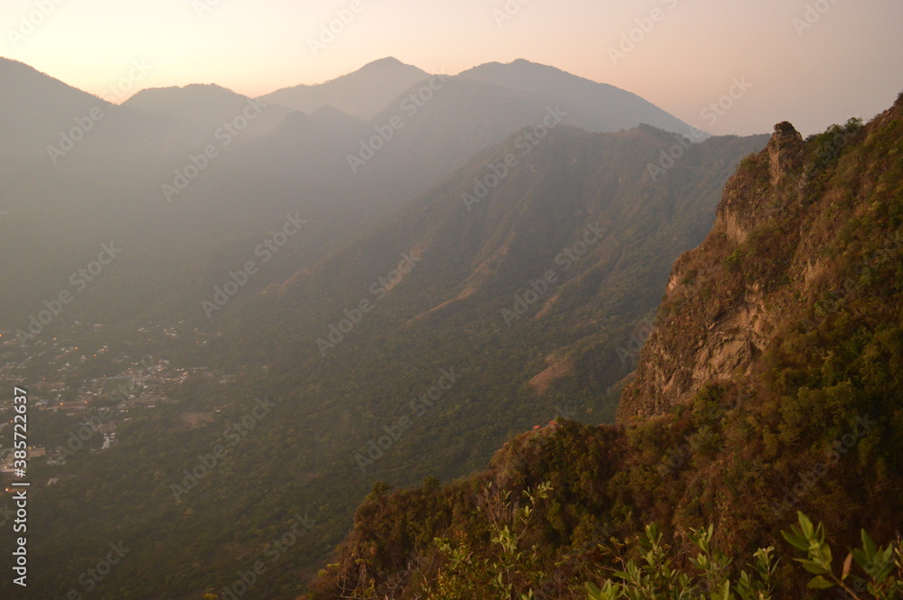 Fototapeta premium Sunrise over the volcanoes of Lake Atitlan in Guatemala, Central America