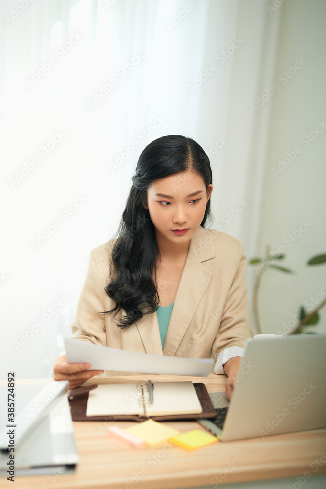Asian businesswoman mother working at home with notebook computer. Concept for home based work. Asian businesswoman mother working at home with notebook computer. Concept for home based work.