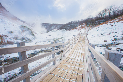 Wooden path of Jigokudani or hell valley in Noboribetsu, Hokkaido, Japan In winter.