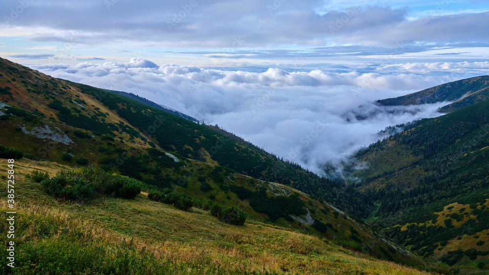 Beautiful view on clouds rolling over mountain ridges, Low Tatras, Slovakia.
